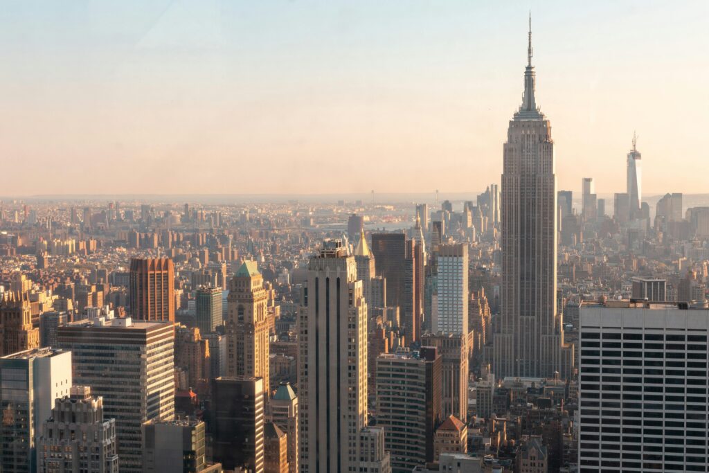 Aerial View of Manhattan Skyline and Skyscrapers During Sunset with Views of the River and Bay in Background